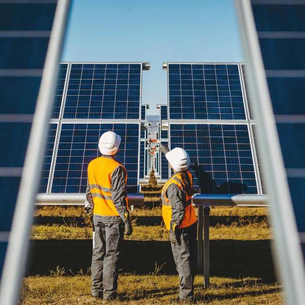 2 man having inspection on solar panels