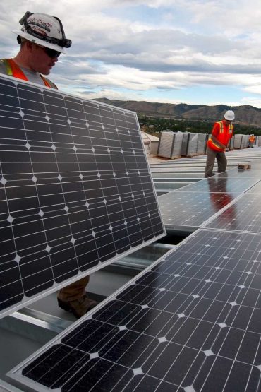 group of mans having operation maintenance in solar panels